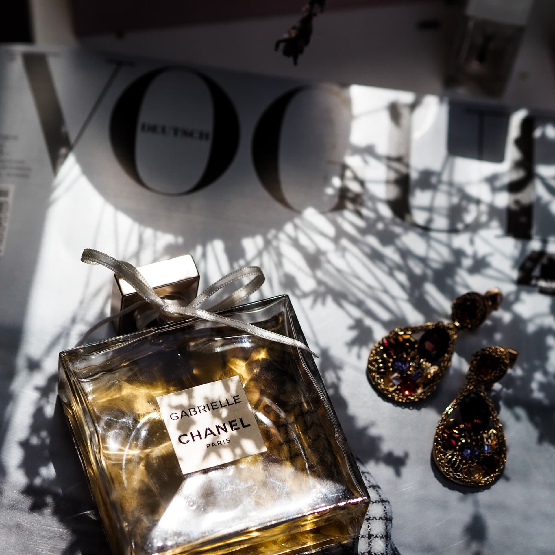 Verra creative direction services — luxury Chanel perfume and Vogue magazine styling
